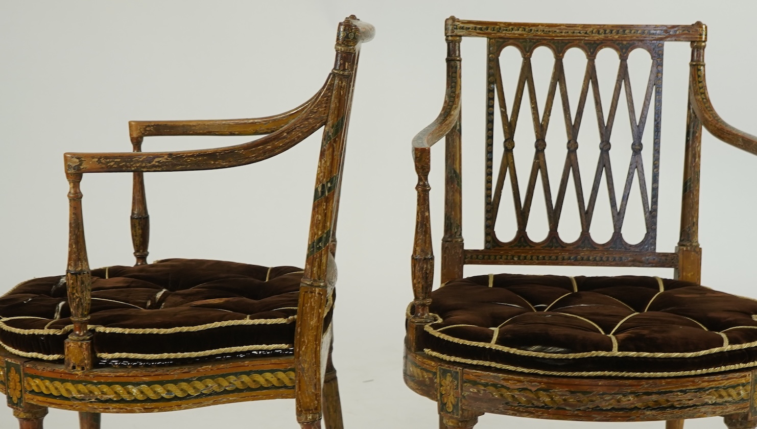 A set of six Sheraton period painted decorated cane seat elbow chairs